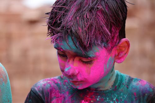 Free Boy in Black Shirt with Pink Powder on his Face Stock Photo