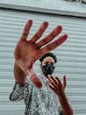 Man in White and Black Button Up Shirt Wearing Black Face Mask