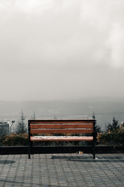 Free A solitary bench stands in a foggy Turkish landscape, creating a serene urban scene. Stock Photo
