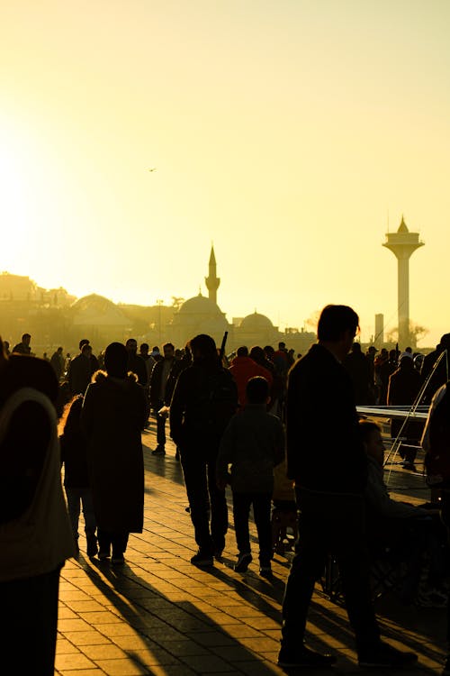 People Walking on the Street during Sunset