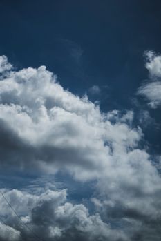 A captivating image of fluffy clouds against a deep blue sky, showcasing nature's beauty.