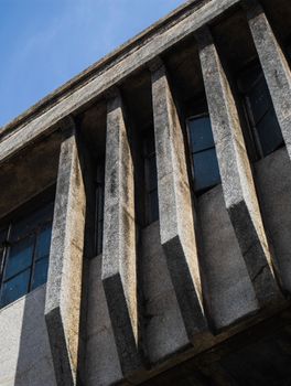 Close-up of a brutalist building facade showcasing geometric concrete design and shadows.. close, brutalist, building