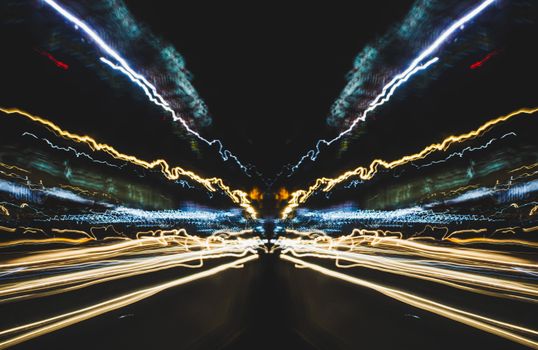 Long exposure capture showing vibrant light trails, creating a dynamic cityscape effect at night.