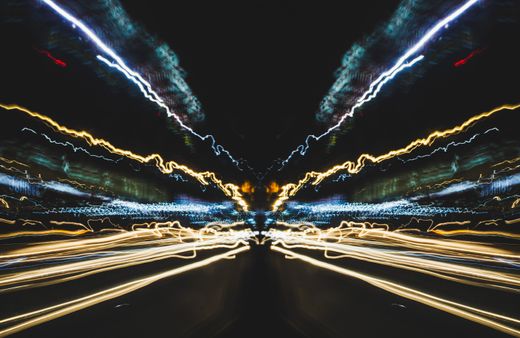 Long-exposure light trails on a night road — photo by Nothing Ahead on Pexels