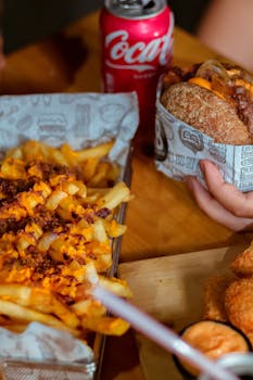 Enjoy a delicious fast food meal with a burger, fries, and Coca-Cola.