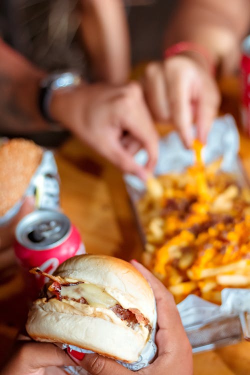 A Hand Holding a Burger