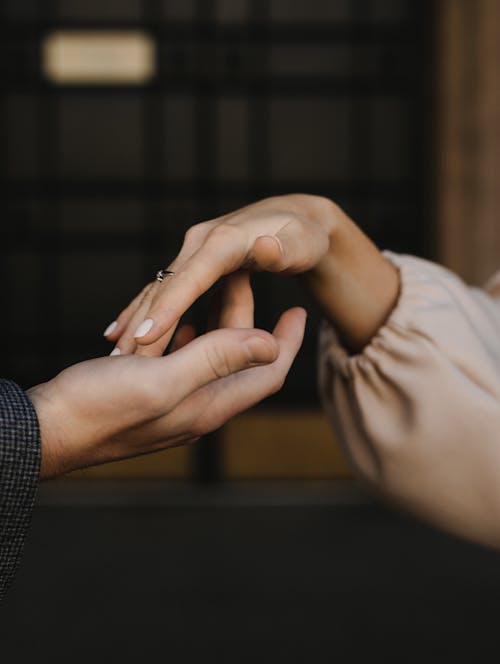 Hands of Man and Woman Touching Delicately