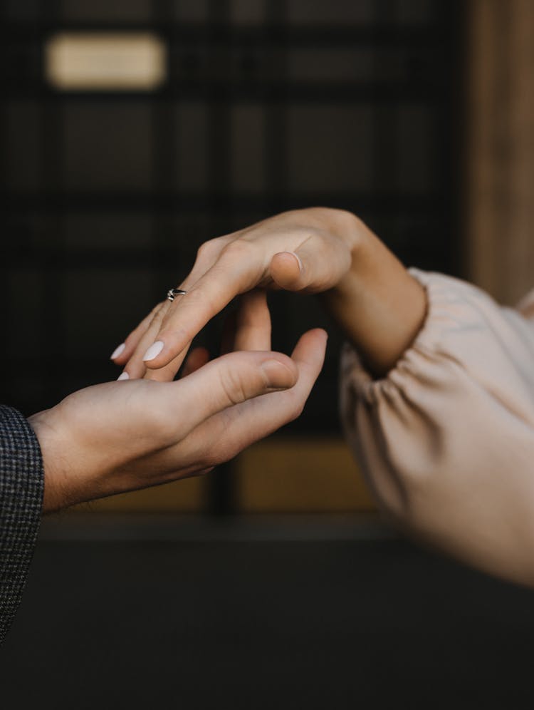 Hands Of Man And Woman Touching Delicately