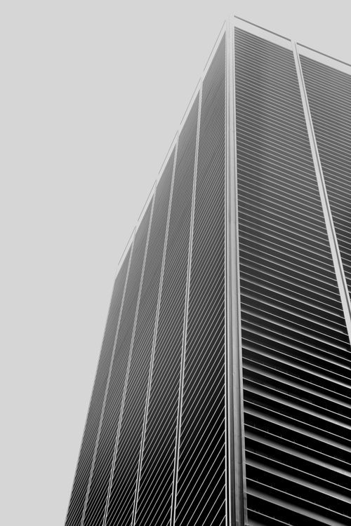 Free Dramatic low angle shot of a New York City skyscraper in grayscale, showcasing modern architecture. Stock Photo