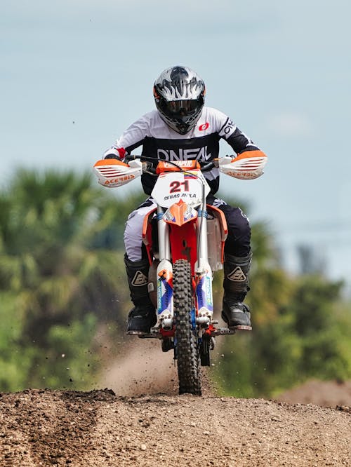 Man Riding a Motorbike on Dirt Road