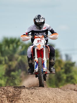 Exciting motocross race showcasing a biker jumping on a dirt track in Miami.
