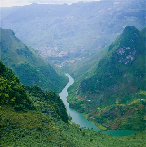 Aerial View of Mountains and River in the Valley