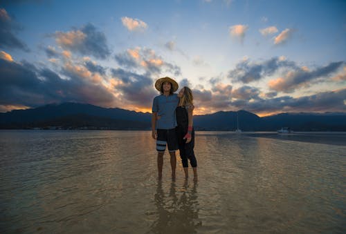 Free Two Person Standing on Body of Water Stock Photo