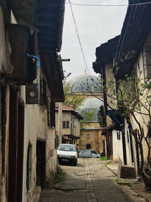 A Car Parked Between Buildings