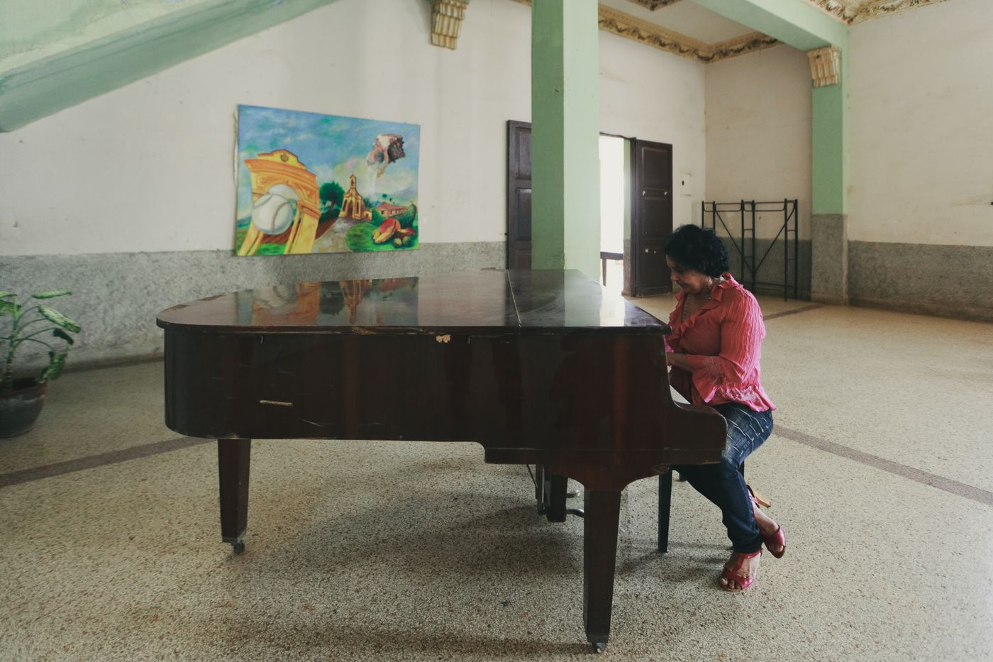 A pianist playing a grand piano in an artistic concert room