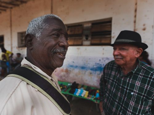 Free Candid shot of two elderly men in conversation, capturing the vibrancy of community interaction outdoors. Stock Photo