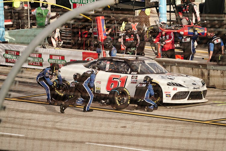 People Changing Tires In The Pit