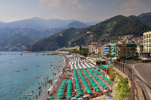 People on the Beach near Mountains