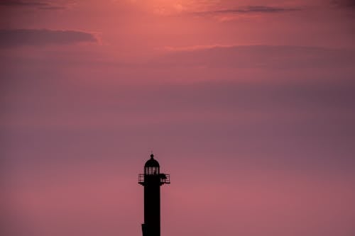Free Silhouette of a Lighthouse During Sunset Stock Photo