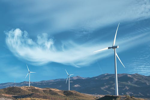 Free Photograph of Windmills Under a Cloudy Sky Stock Photo