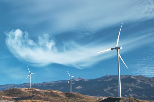 Photograph of Windmills Under a Cloudy Sky