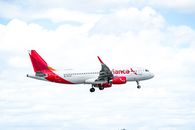 White and Red Passenger Plane in Flight