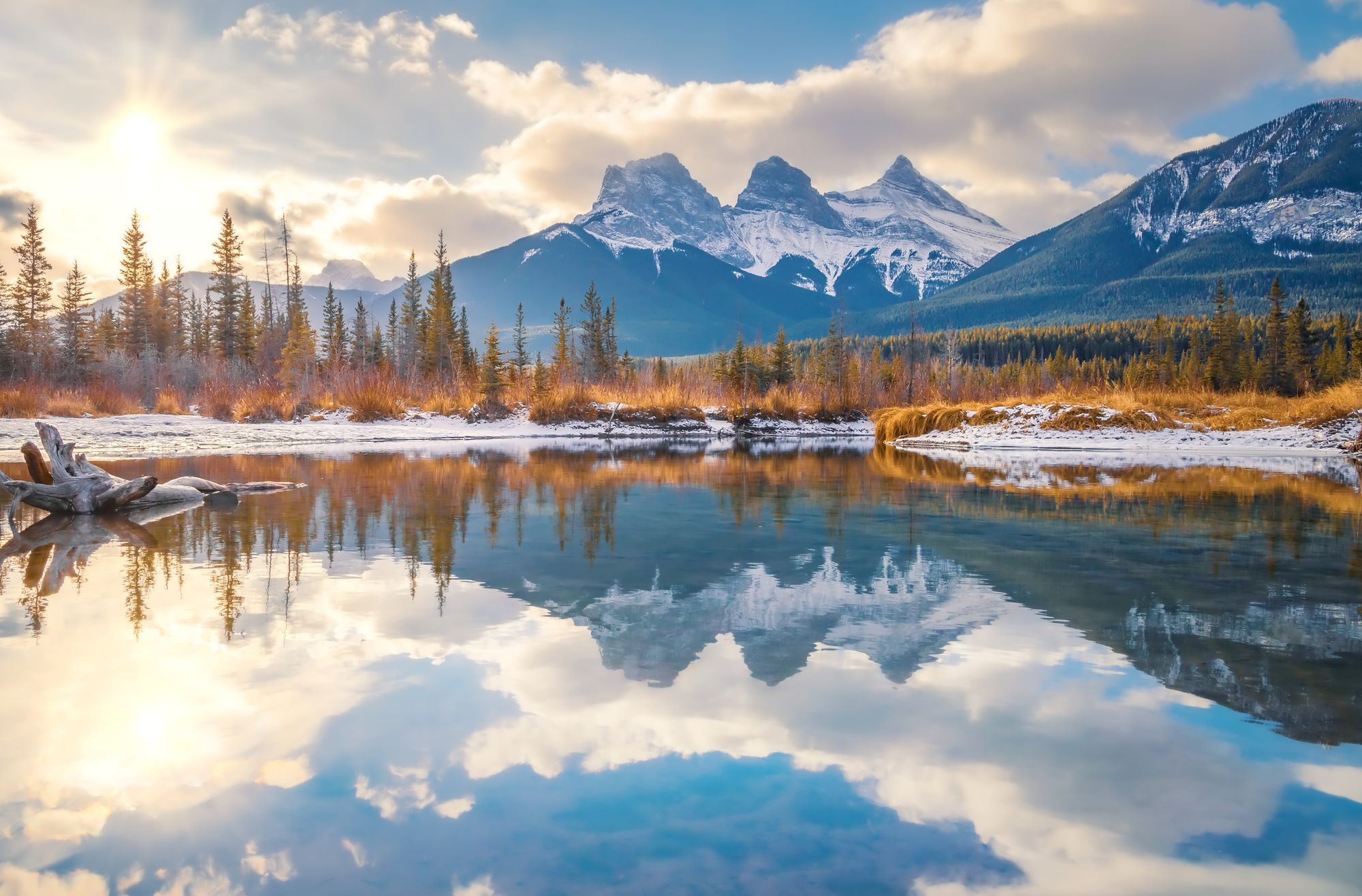 Three Sisters mountains reflected in the Bow River near Canmore