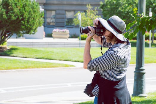 Woman Standing on Green Grass Taking Picture