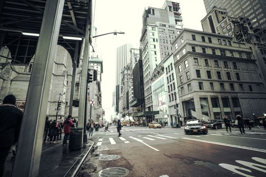 Street view of bustling New York City with iconic skyscrapers and vibrant urban life.