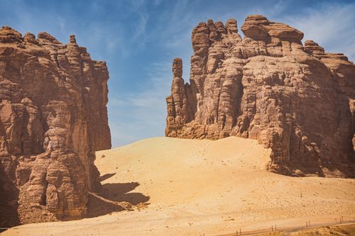 Free Explore stunning sandstone formations in an arid desert landscape under a bright blue sky. Stock Photo