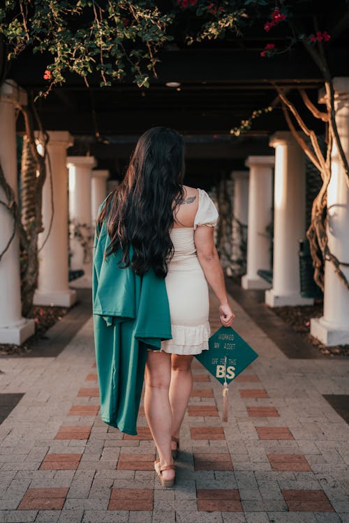 Back View of a Woman Holding a Mortarboard