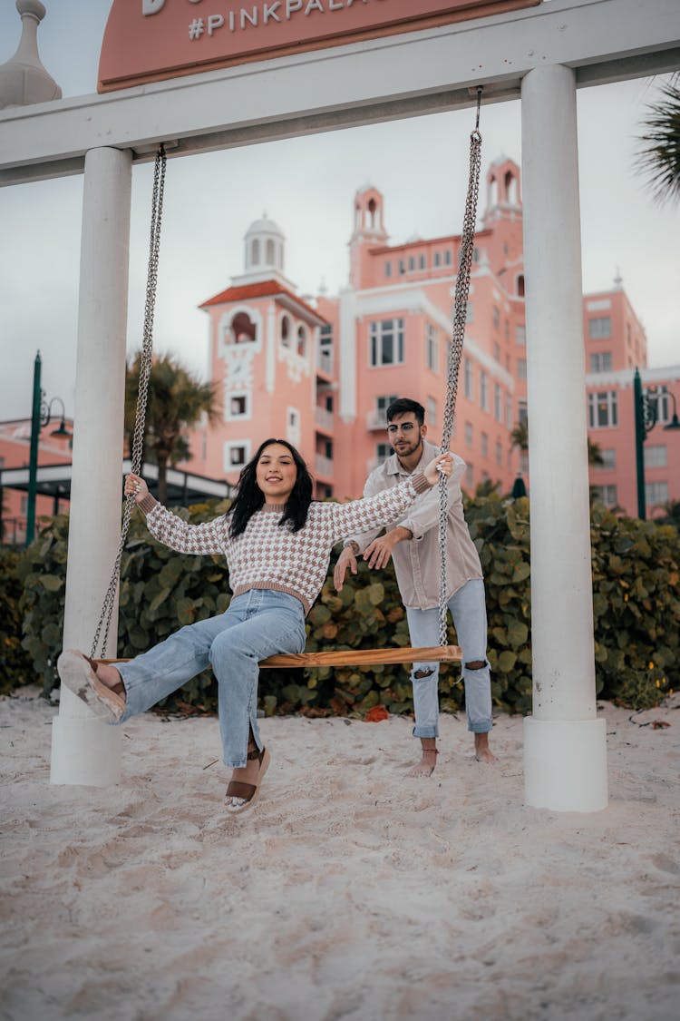 Photo Of A Man Pushing A Woman On A Swing