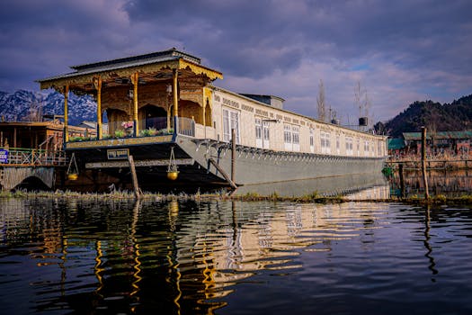Scenic view of a traditional houseboat on Dal Lake, Srinagar under a vivid sky reflecting in calm waters.