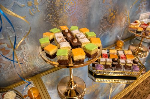 Free Delightful assortment of colorful mini cakes elegantly arranged on trays, perfect for celebrations. Stock Photo