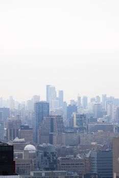Toronto skyline with skyscrapers visible through a misty sky. Captured from an elevated perspective.