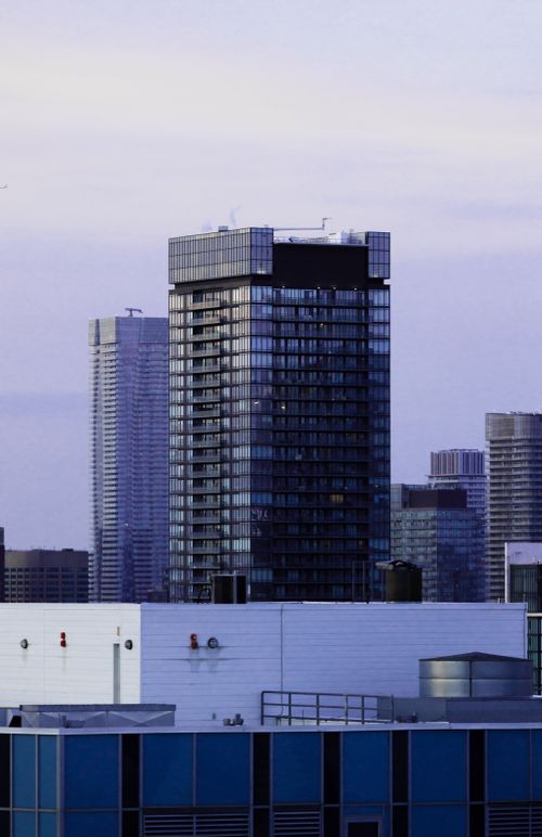 Free View of modern skyscrapers in downtown Toronto, Canada during dusk, showcasing urban architecture. Stock Photo