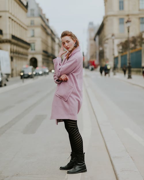 Free Woman in Pink Coat Standing on Sidewalk Stock Photo