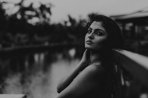 Grayscale Photo of Woman With Hand on Neck 