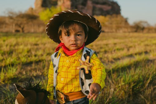 A Young Boy Wearing Woody Costume