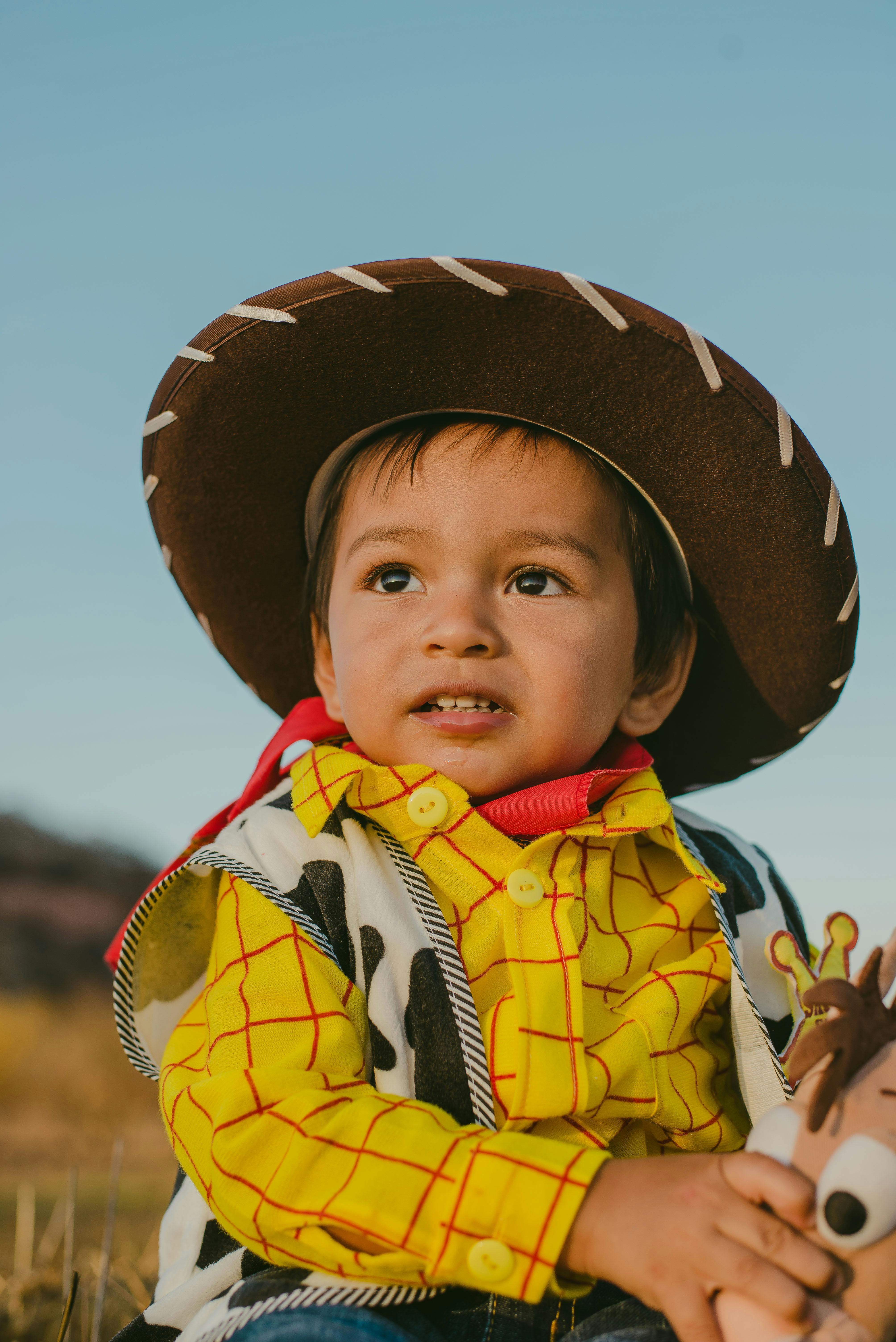 boy in sheriff woody costume looking up