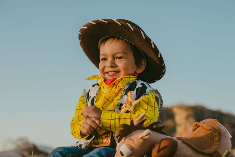 A Boy Wearing A Cowboy Costume