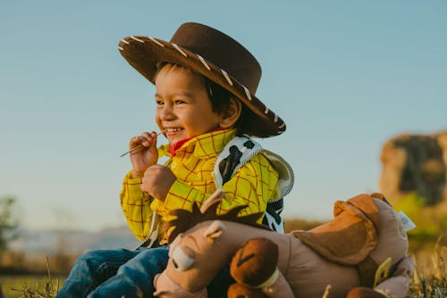Close-Up Shot of a Boy in Cowboy Costume Smiling