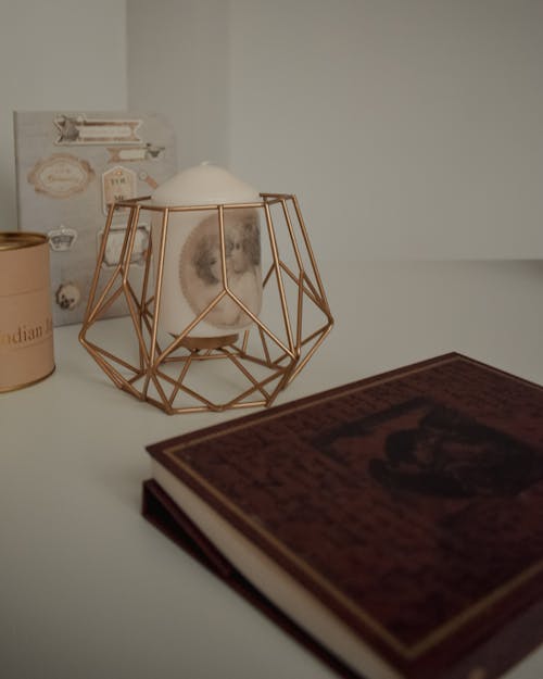 Close-Up Photo of a Notebook Near a Candle