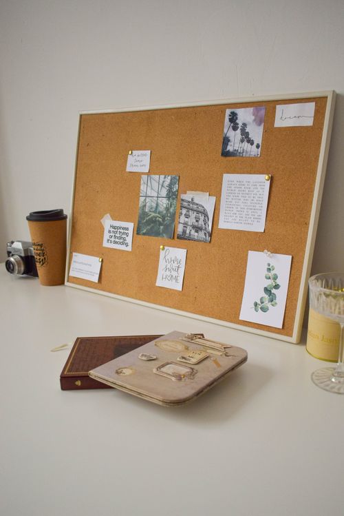Free Cozy workspace featuring a cork board with inspiration notes and a stylish planner. Stock Photo