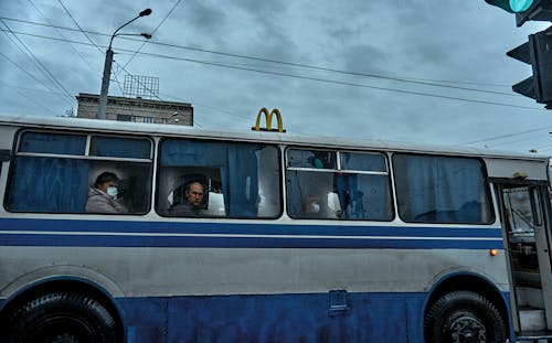 Free People Sitting on a Bus under a Gloomy Sky Stock Photo