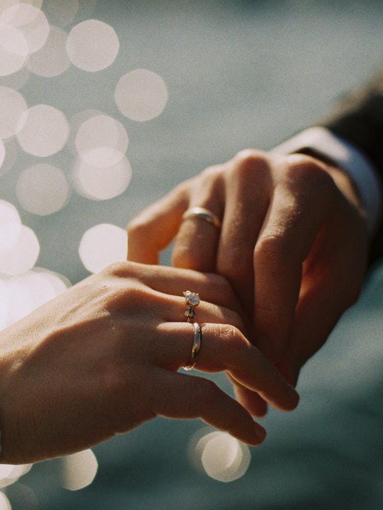 Hands Of Husband And Wife With Their Wedding Rings