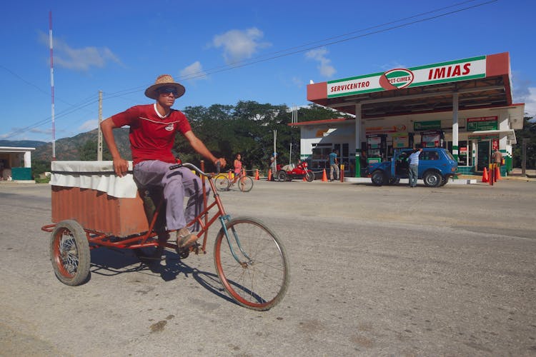 Man Riding A Bicycle With A Carriage