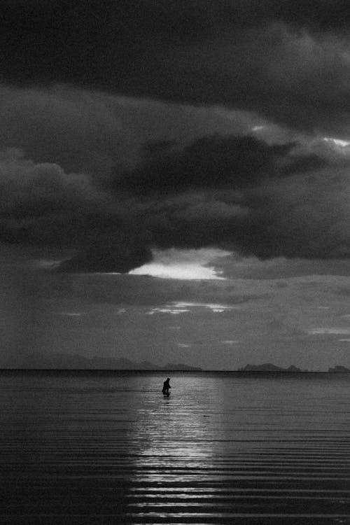 Monochrome Shot of a Person on the Sea