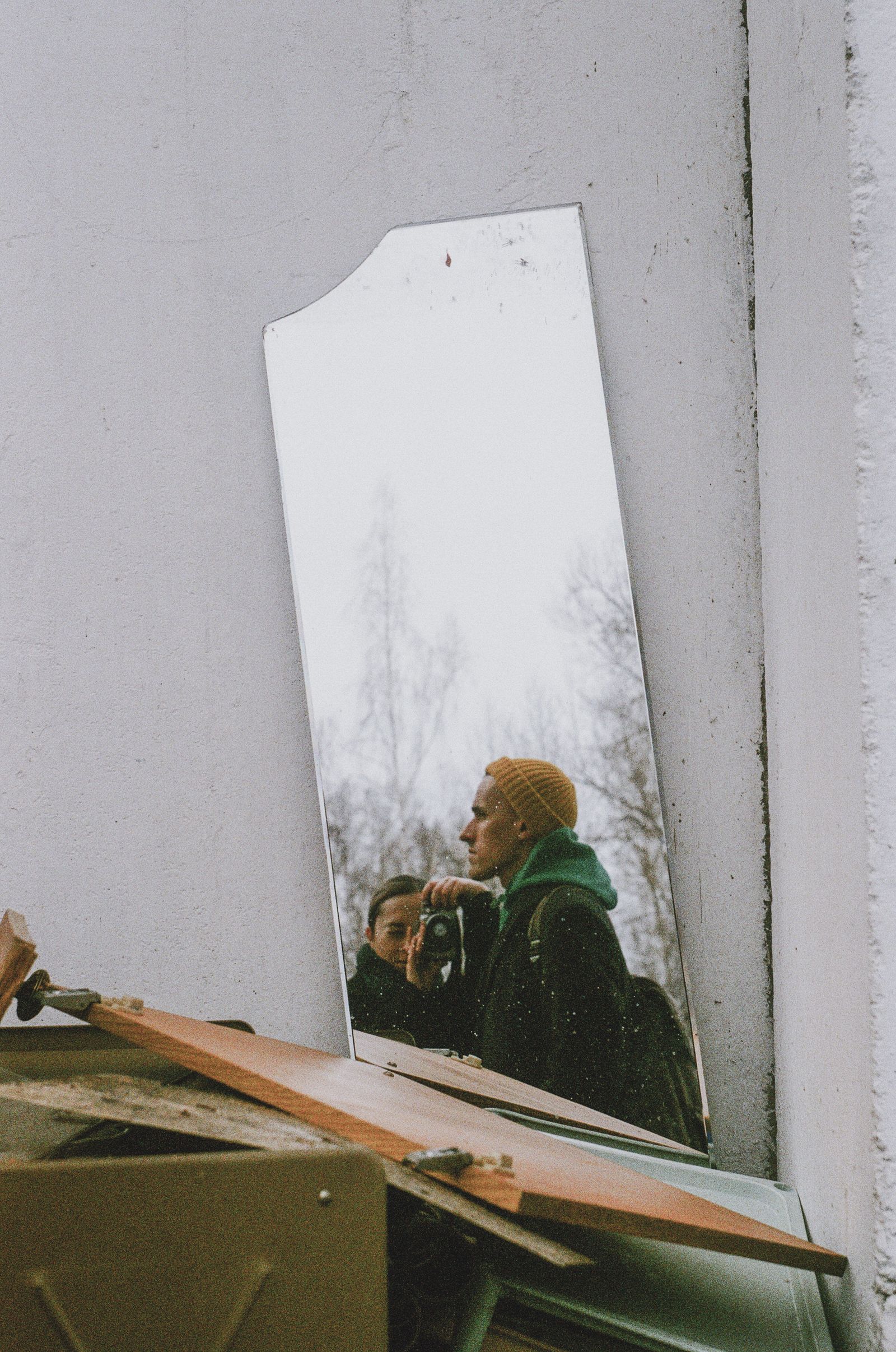 Artistic shot of reflections fragmented across a broken outdoor mirror