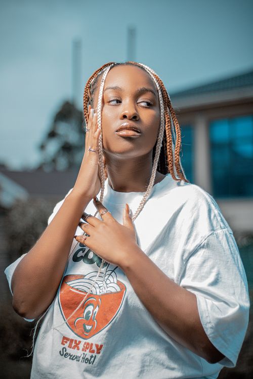 Free A fashionable African woman with braided hair poses outdoors in Bizana, South Africa. Stock Photo
